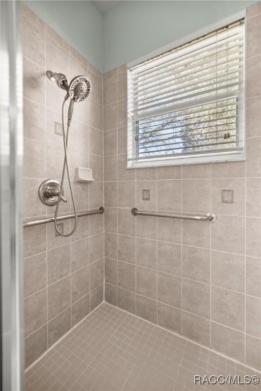 full bath with a tile shower