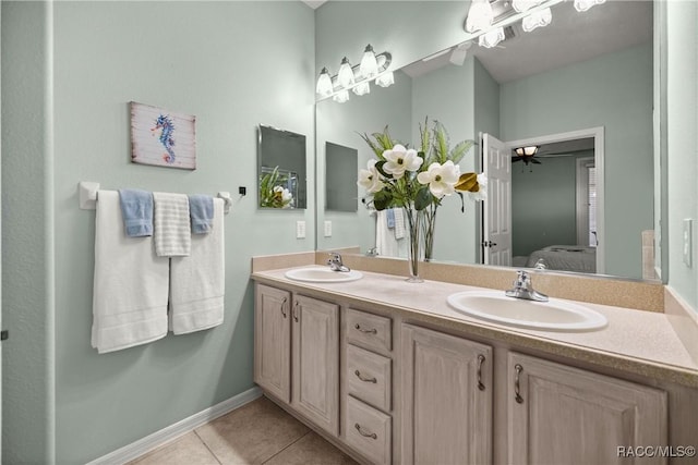 ensuite bathroom featuring double vanity, ensuite bath, a sink, and tile patterned floors