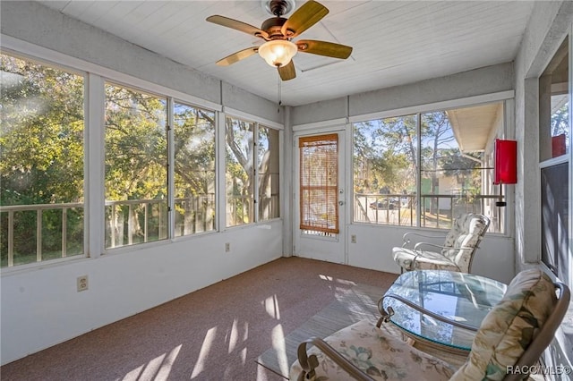 unfurnished sunroom featuring ceiling fan