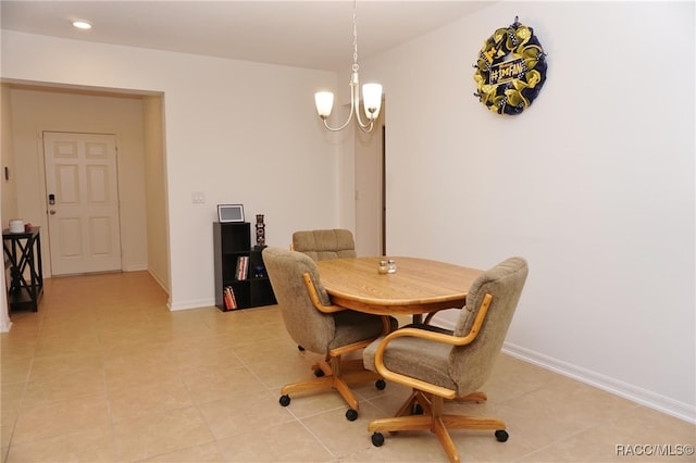 dining area featuring light tile patterned flooring and an inviting chandelier