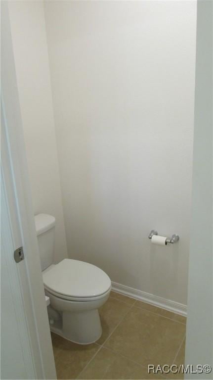 bathroom with tile patterned flooring and toilet