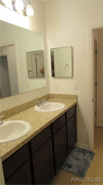 bathroom featuring tile patterned flooring and vanity