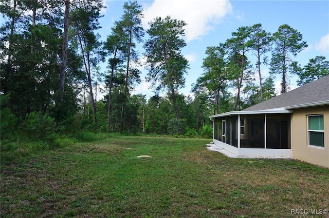 view of yard featuring a sunroom