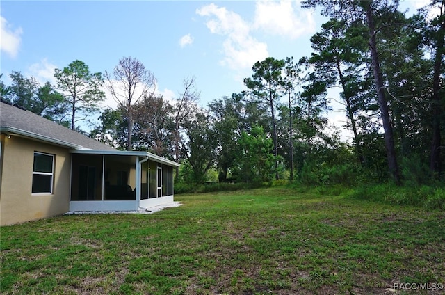 view of yard with a sunroom