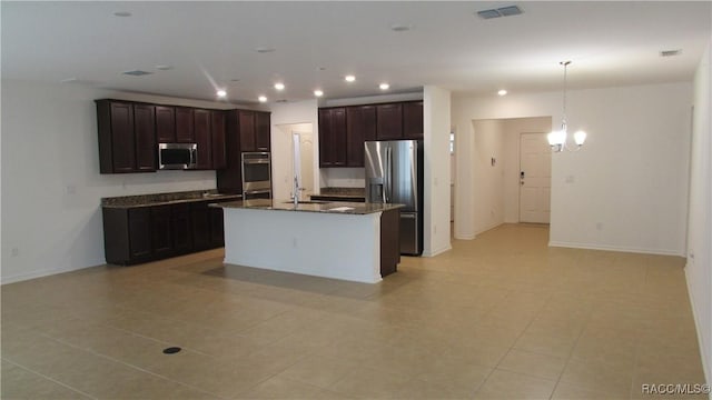 kitchen featuring a center island with sink, hanging light fixtures, a notable chandelier, dark brown cabinets, and stainless steel appliances