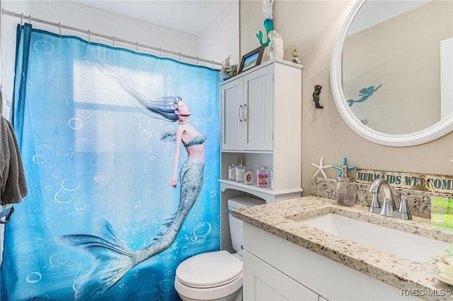 bathroom with a shower with curtain, vanity, and toilet