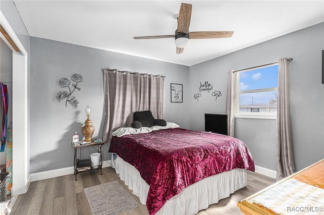 bedroom with ceiling fan and hardwood / wood-style floors