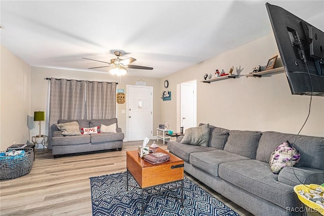 living room with hardwood / wood-style flooring and ceiling fan