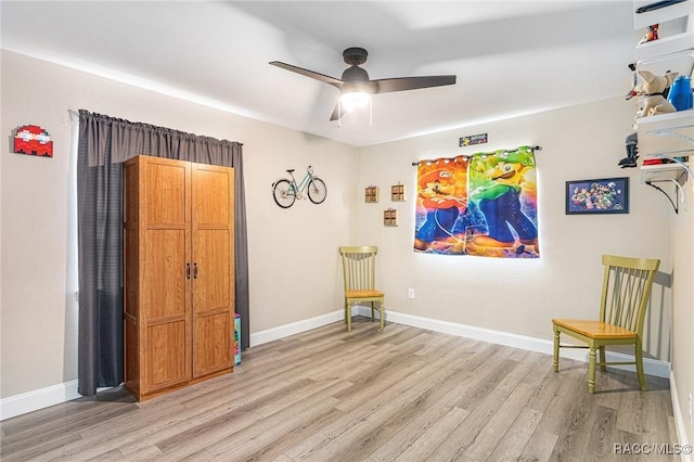 sitting room featuring light hardwood / wood-style flooring and ceiling fan