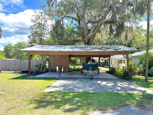 view of car parking with a detached carport and driveway