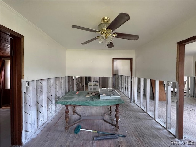 dining room featuring a ceiling fan, wood-type flooring, and ornamental molding