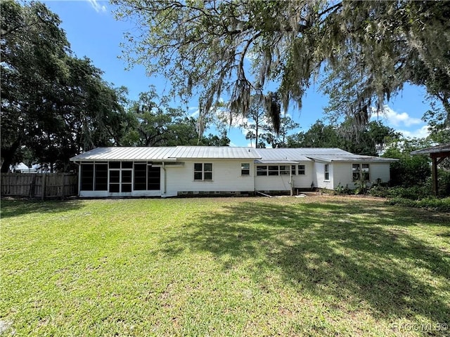 rear view of house with a sunroom and metal roof