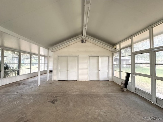 unfurnished sunroom featuring lofted ceiling and healthy amount of natural light