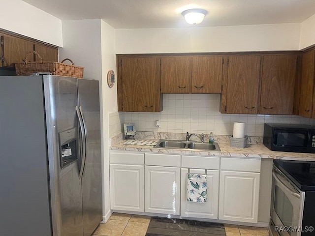 kitchen with white cabinetry, appliances with stainless steel finishes, sink, and decorative backsplash