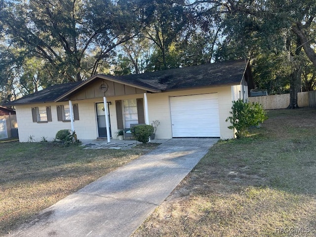 ranch-style house featuring a garage and a front yard