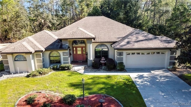 view of front facade featuring a front lawn and a garage