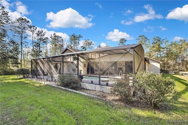 rear view of property with a lawn, glass enclosure, and a patio area