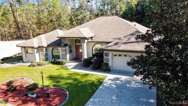 view of front of home with a garage and a front yard