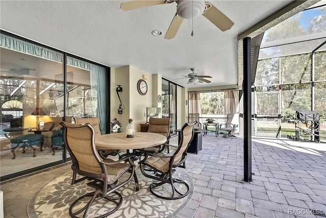 sunroom / solarium featuring ceiling fan