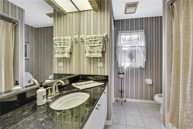 bathroom with tile patterned floors, vanity, and toilet