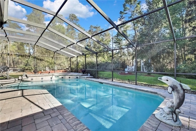 view of swimming pool featuring a lanai, a yard, and a patio