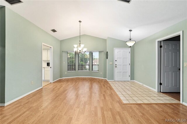 220 E Liberty St, Hernando, FL 34442 - entryway with vaulted ceiling, a chandelier, and light wood finished floors