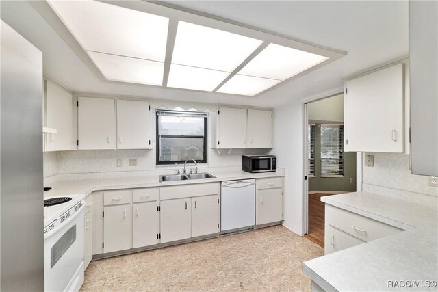 220 E Liberty St, Hernando, FL 34442 - kitchen with white appliances, healthy amount of natural light, light countertops, and under cabinet range hood