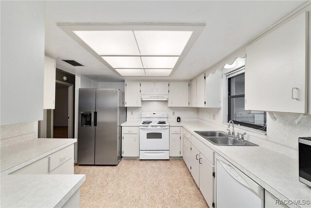 220 E Liberty St, Hernando, FL 34442 - kitchen with white appliances, under cabinet range hood, light countertops, and white cabinetry