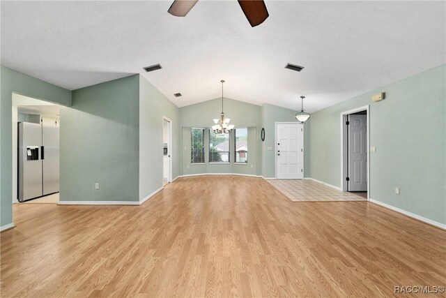 220 E Liberty St, Hernando, FL 34442 - unfurnished living room with a ceiling fan, vaulted ceiling, light wood-type flooring, and a chandelier