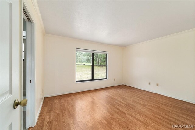 220 E Liberty St, Hernando, FL 34442 - empty room with light wood-style floors and crown molding