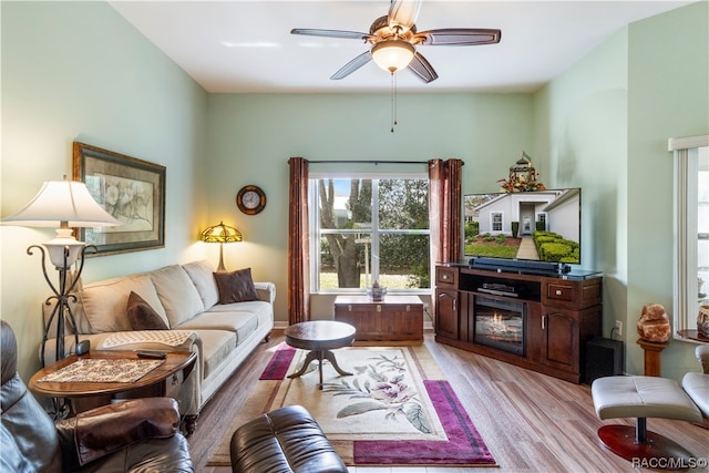 living room featuring ceiling fan and light wood-type flooring