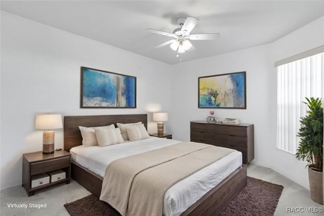 bedroom featuring a ceiling fan and light colored carpet