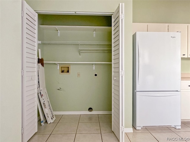 laundry area featuring electric dryer hookup, light tile patterned floors, and hookup for a washing machine