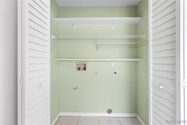 laundry area with hookup for a washing machine, light tile patterned flooring, electric dryer hookup, laundry area, and baseboards