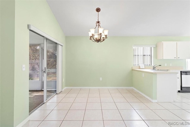 unfurnished dining area featuring a notable chandelier, baseboards, a sink, and light tile patterned flooring