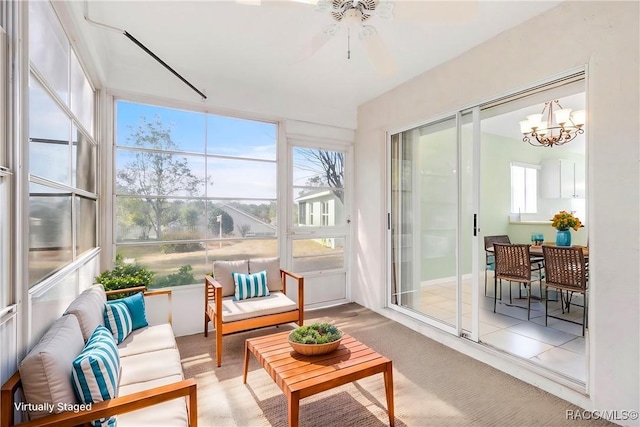 sunroom / solarium with ceiling fan with notable chandelier