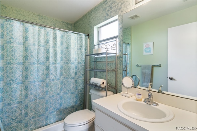 bathroom featuring walk in shower, vanity, and toilet