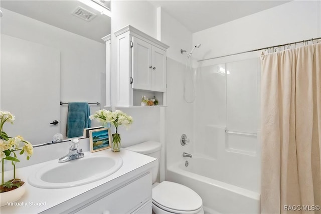 full bathroom featuring toilet, shower / tub combo, visible vents, and vanity