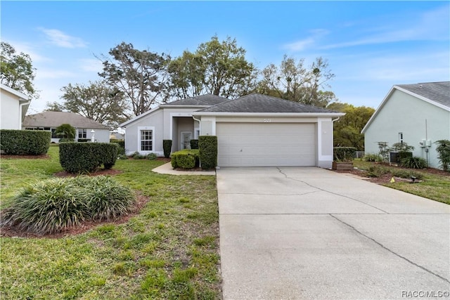 view of front of property with a front yard, concrete driveway, an attached garage, and stucco siding