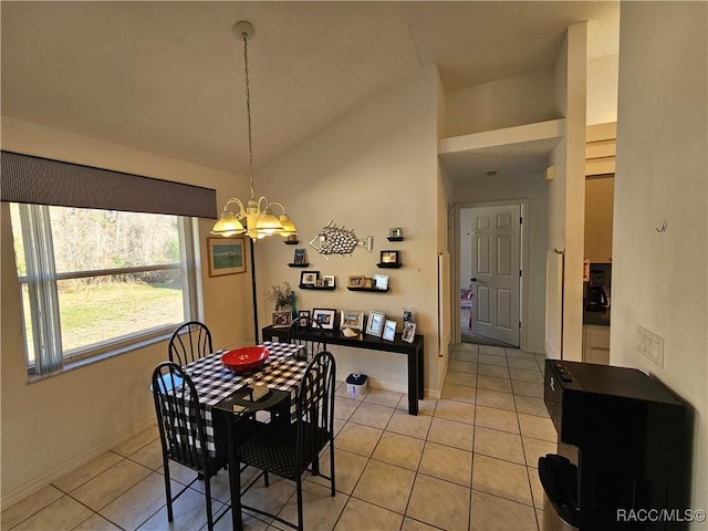 tiled dining room featuring lofted ceiling and a notable chandelier