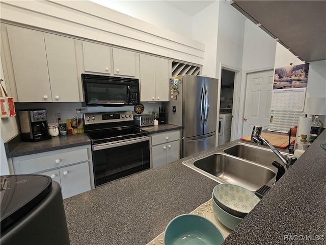 kitchen with washer / clothes dryer, sink, and appliances with stainless steel finishes