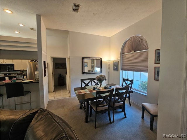 dining room featuring light carpet