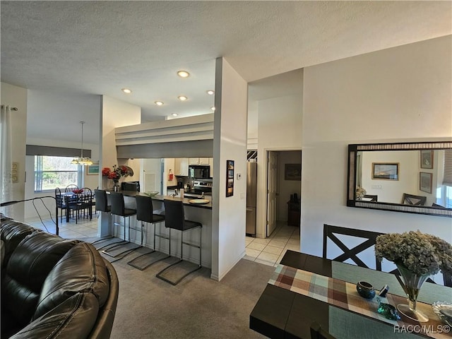 carpeted living room with an inviting chandelier and a textured ceiling