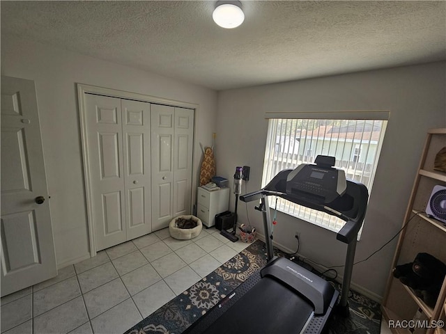 miscellaneous room with a textured ceiling and light tile patterned flooring