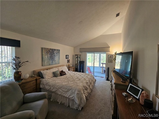 carpeted bedroom featuring access to exterior, vaulted ceiling, and a textured ceiling