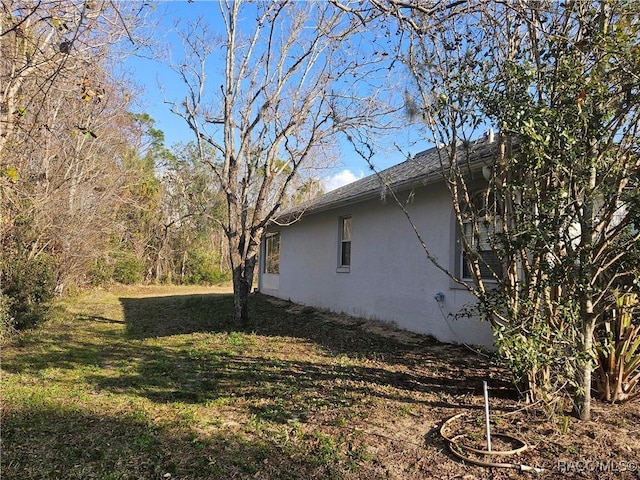 view of property exterior featuring a lawn