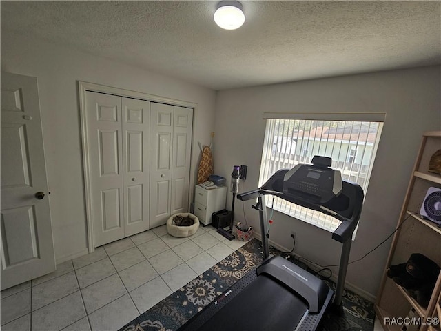 miscellaneous room with a textured ceiling and light tile patterned floors