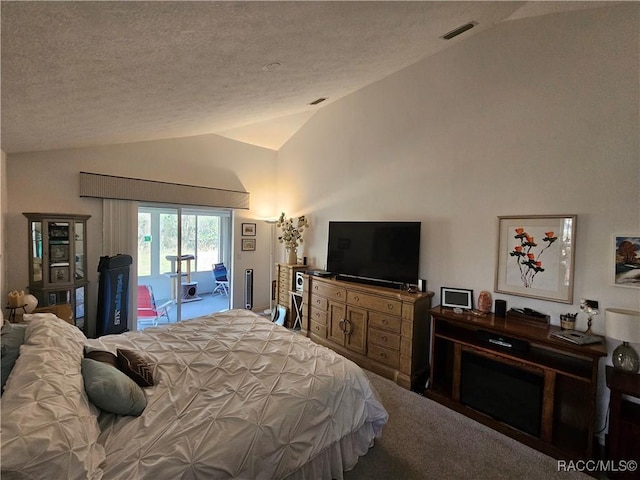 bedroom with carpet floors, vaulted ceiling, a textured ceiling, and access to outside