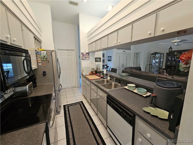 kitchen featuring sink, light tile patterned floors, ceiling fan, white cabinetry, and white dishwasher