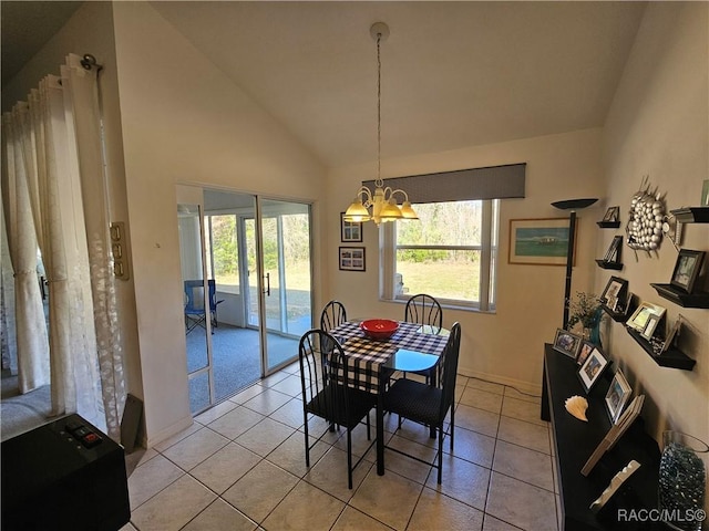 tiled dining space featuring lofted ceiling, a wealth of natural light, and an inviting chandelier